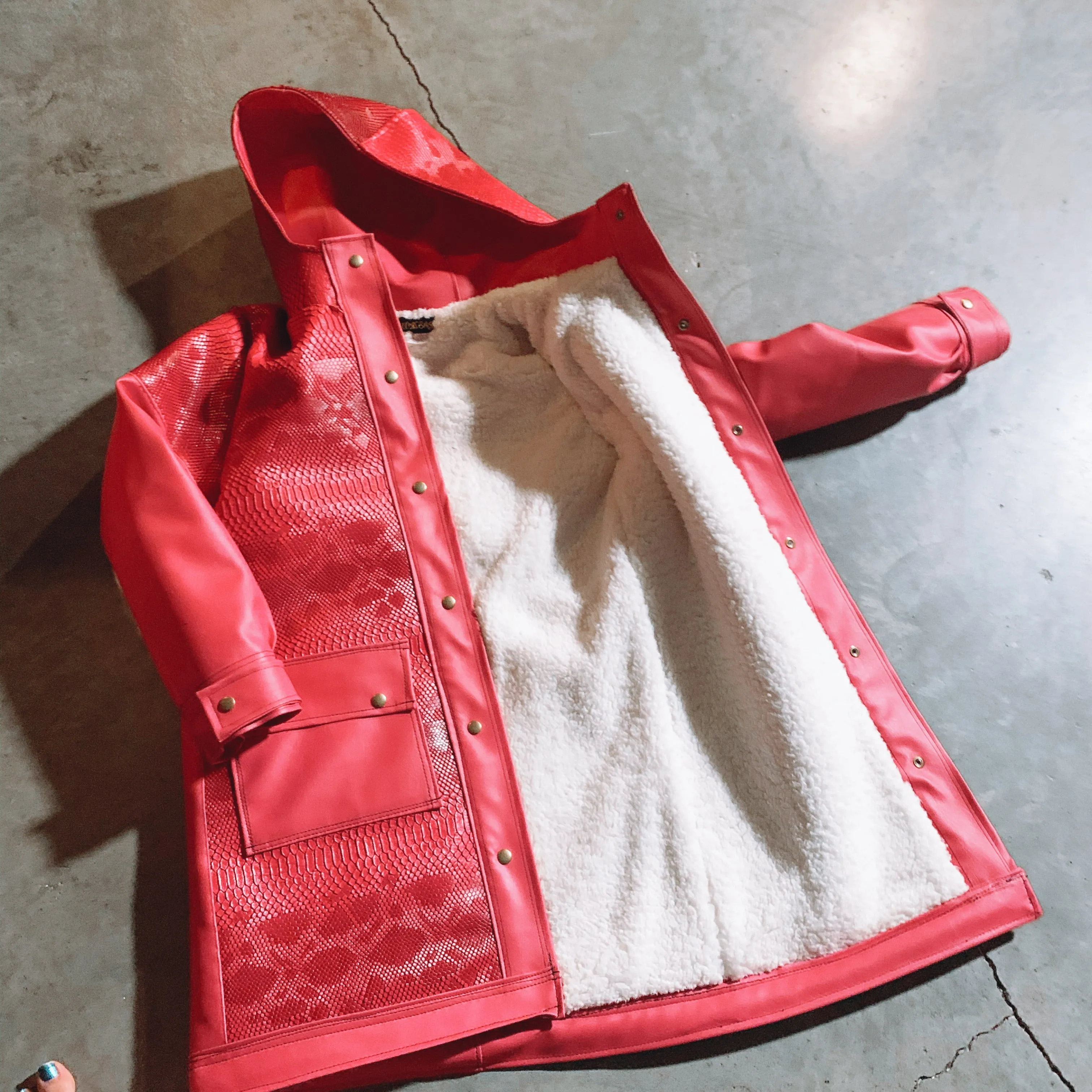 Pink vinyl snake skin rain coat